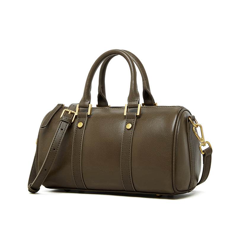 Classic leather barrel handbag with gold hardware and adjustable strap.