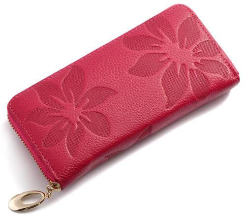 Red leather wallet with embossed floral design and gold zipper detail.