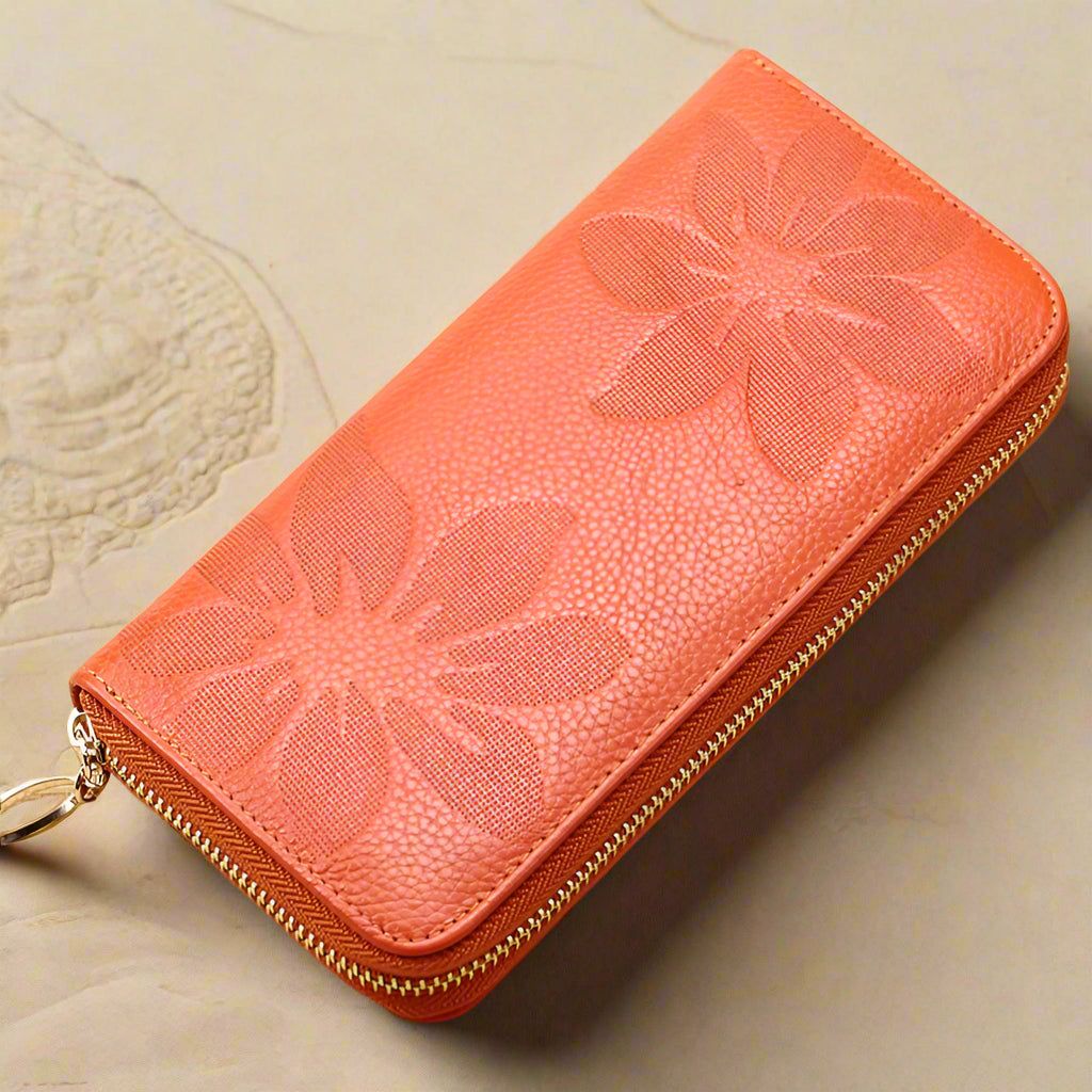 Ladies leather floral wallet with embossed flower design and zip closure on a