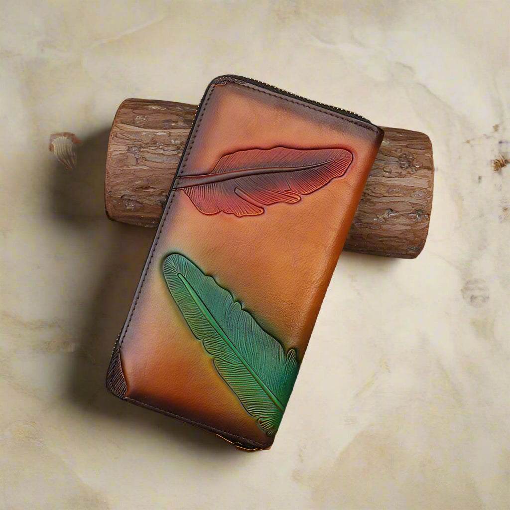 Leather womens leaf wallet with embossed leaf design on handcrafted brown leather surface.