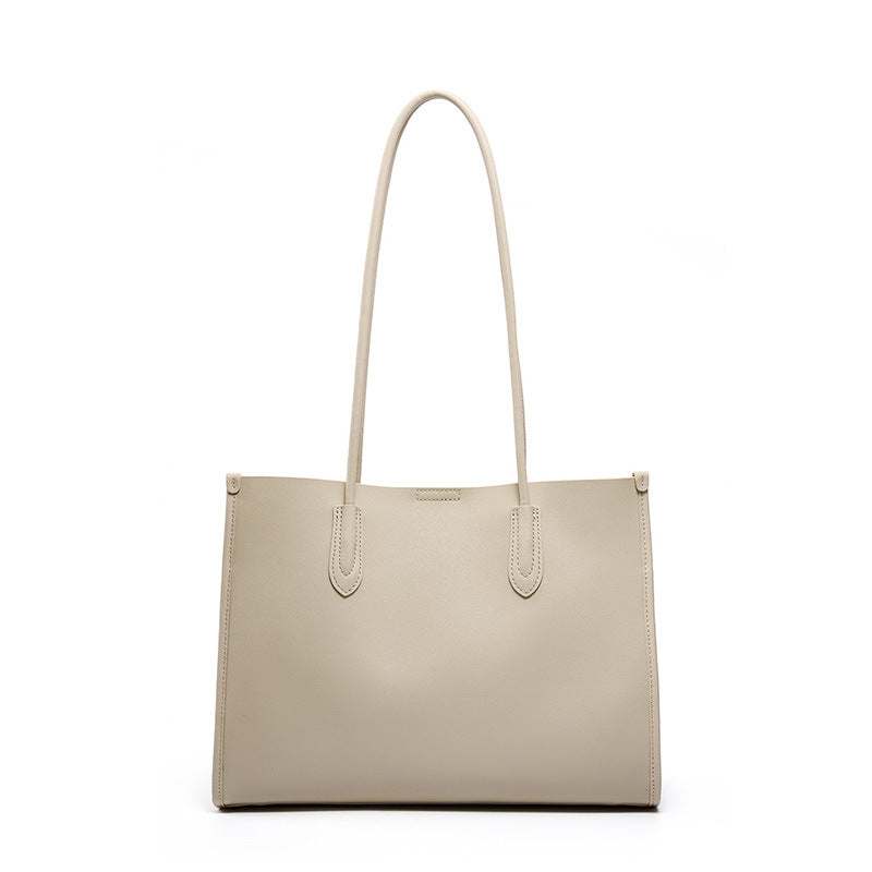 Tote leather bag with long straps, crafted from genuine leather, featuring a minimalist design. Ideal for work,