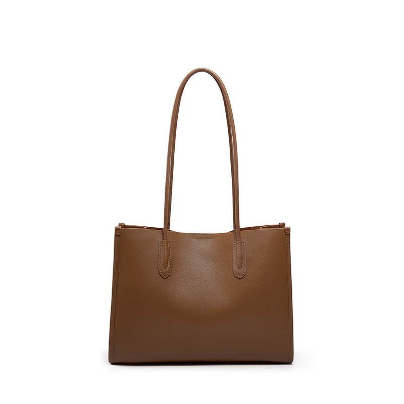 Brown tote leather bag with long handles and sleek, minimalist design.