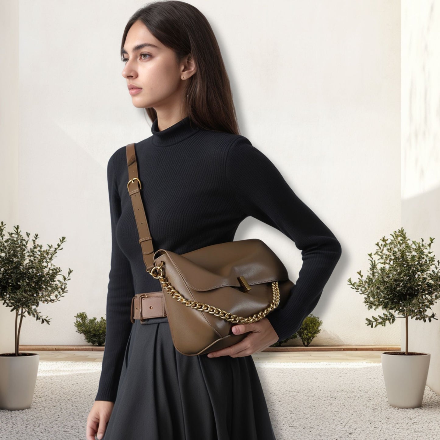 Woman wearing a small messenger purse with leather and chain strap, stylish and versatile fashion accessory.