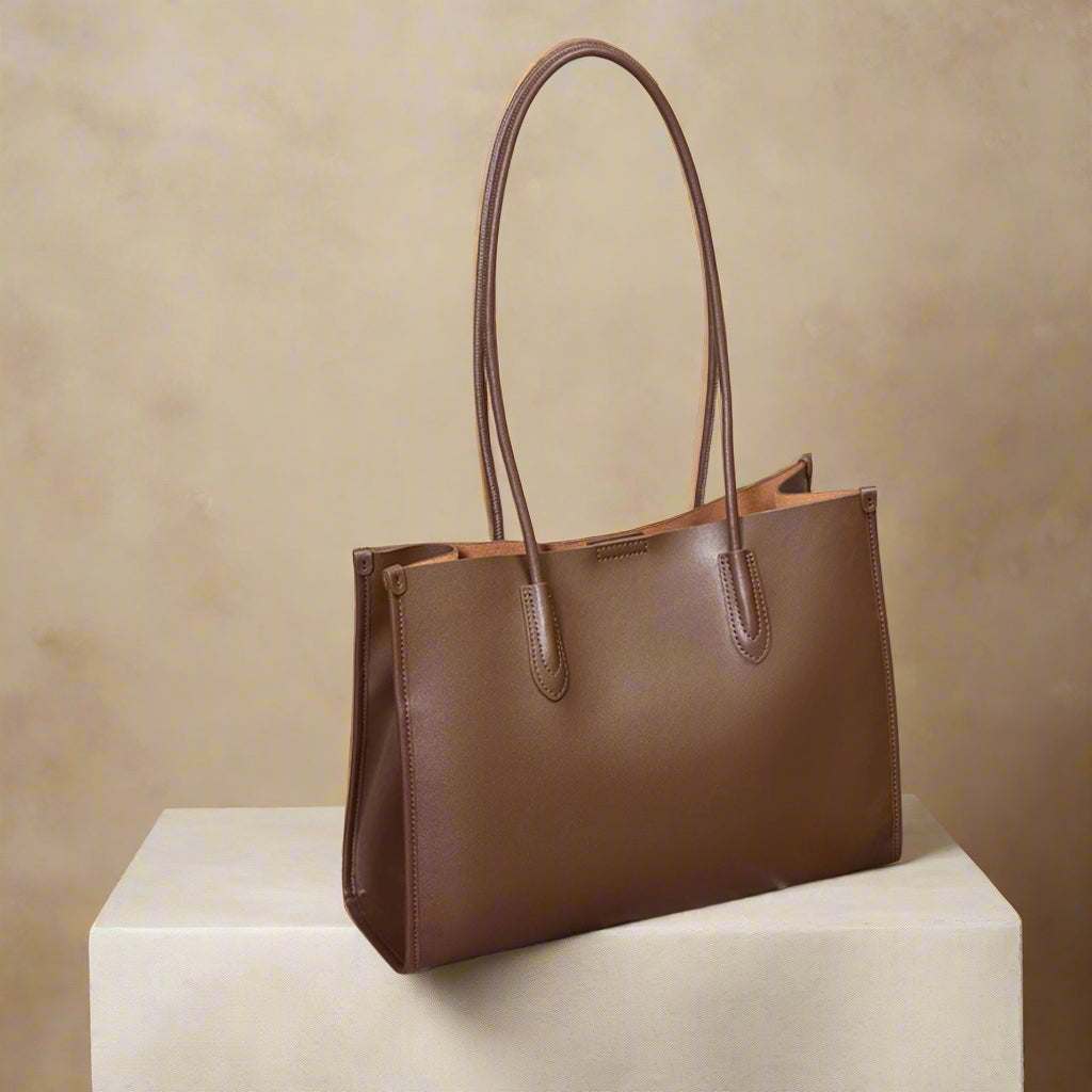 Tote leather bag with reinforced straps and timeless design on a