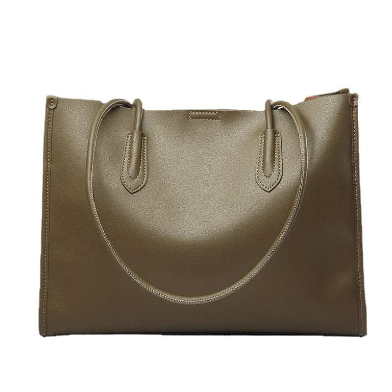 Genuine leather tote bag with reinforced straps and sleek design.