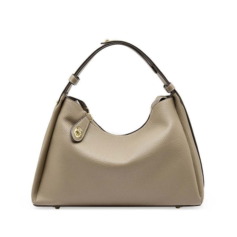 Trapezoid leather crossbody handbag with adjustable strap, featuring lychee-patterned scratch-resistant hardware
