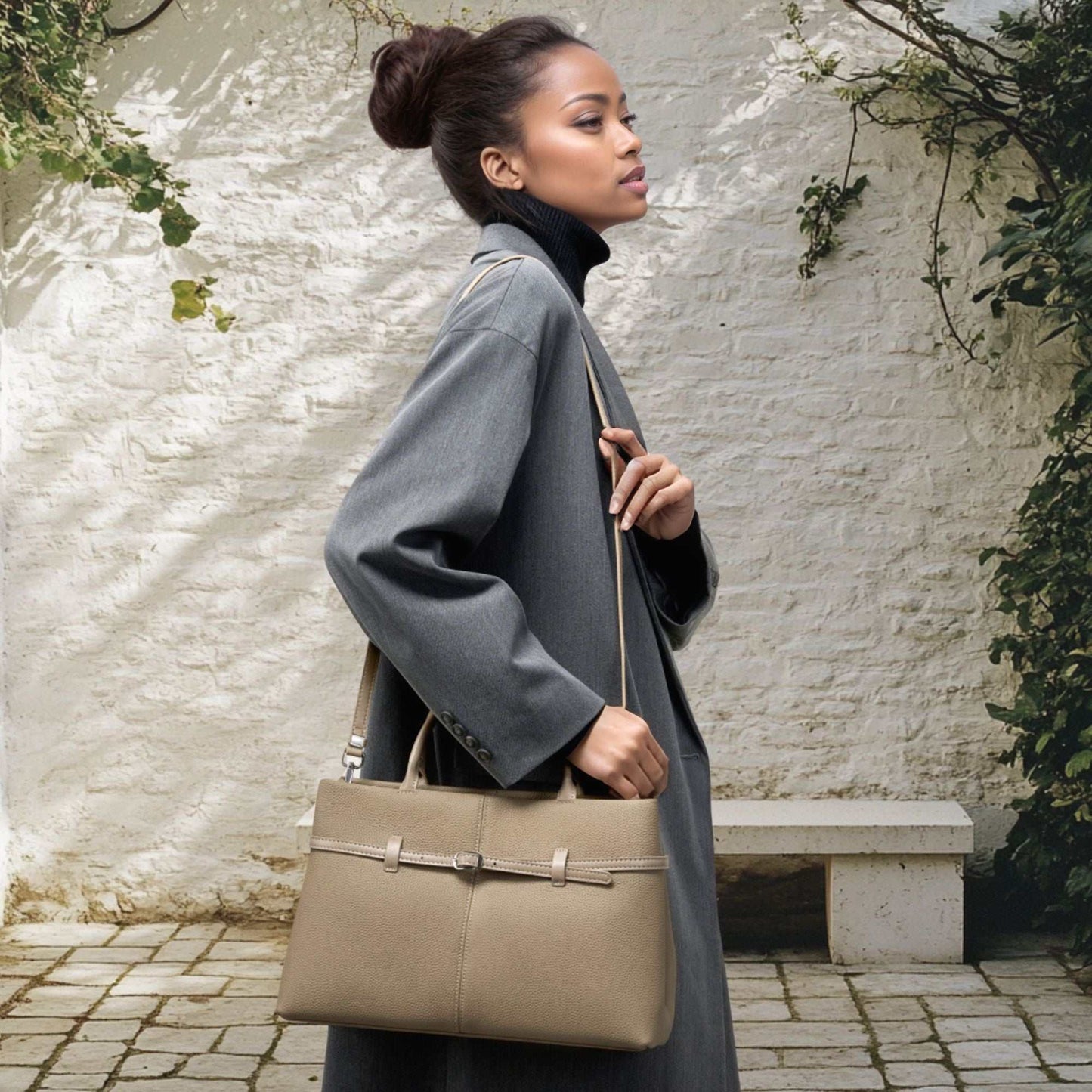 Woman carrying a stylish beige leather briefcase bag