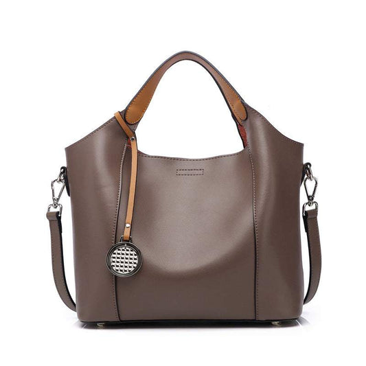 Two-tone leather work bag with handle and detachable shoulder strap.