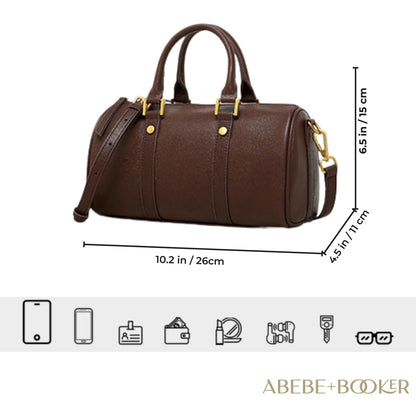 Classic leather barrel handbag with gold hardware, adjustable strap, and multiple pockets for versatile