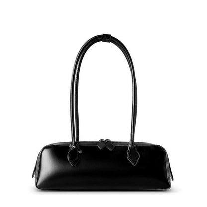 Sleek black leather baguette bag with long handles and double zipper.