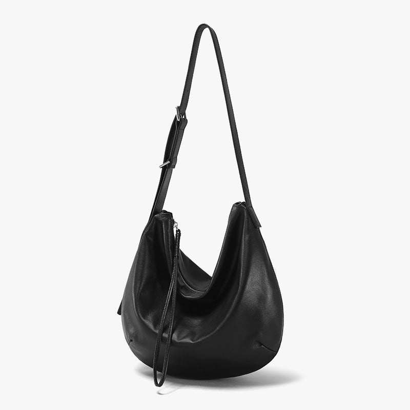 Slouchy crossbody bag in genuine leather with adjustable strap.