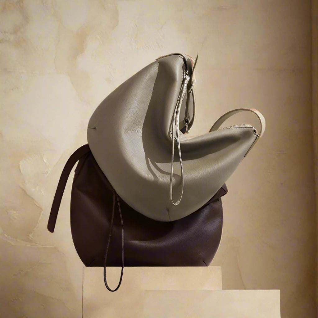 Slouchy crossbody bag made of genuine leather in black, brown, and grey.