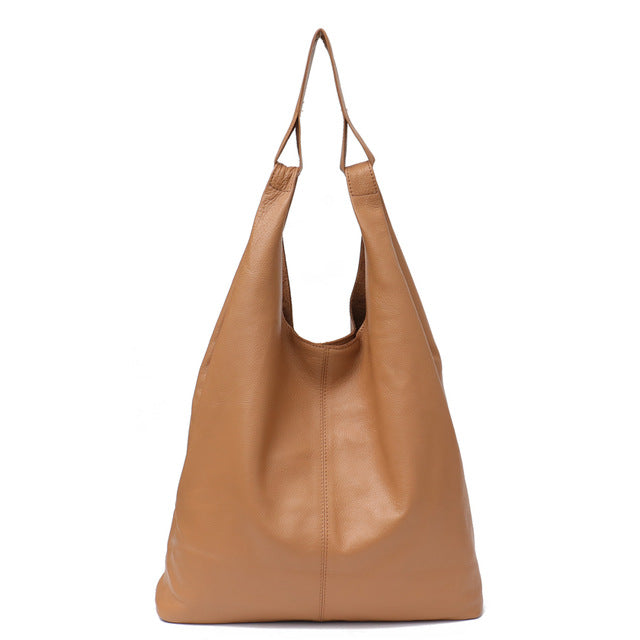 Slouchy leather hobo bag in brown, featuring a soft and spacious design with top handles.