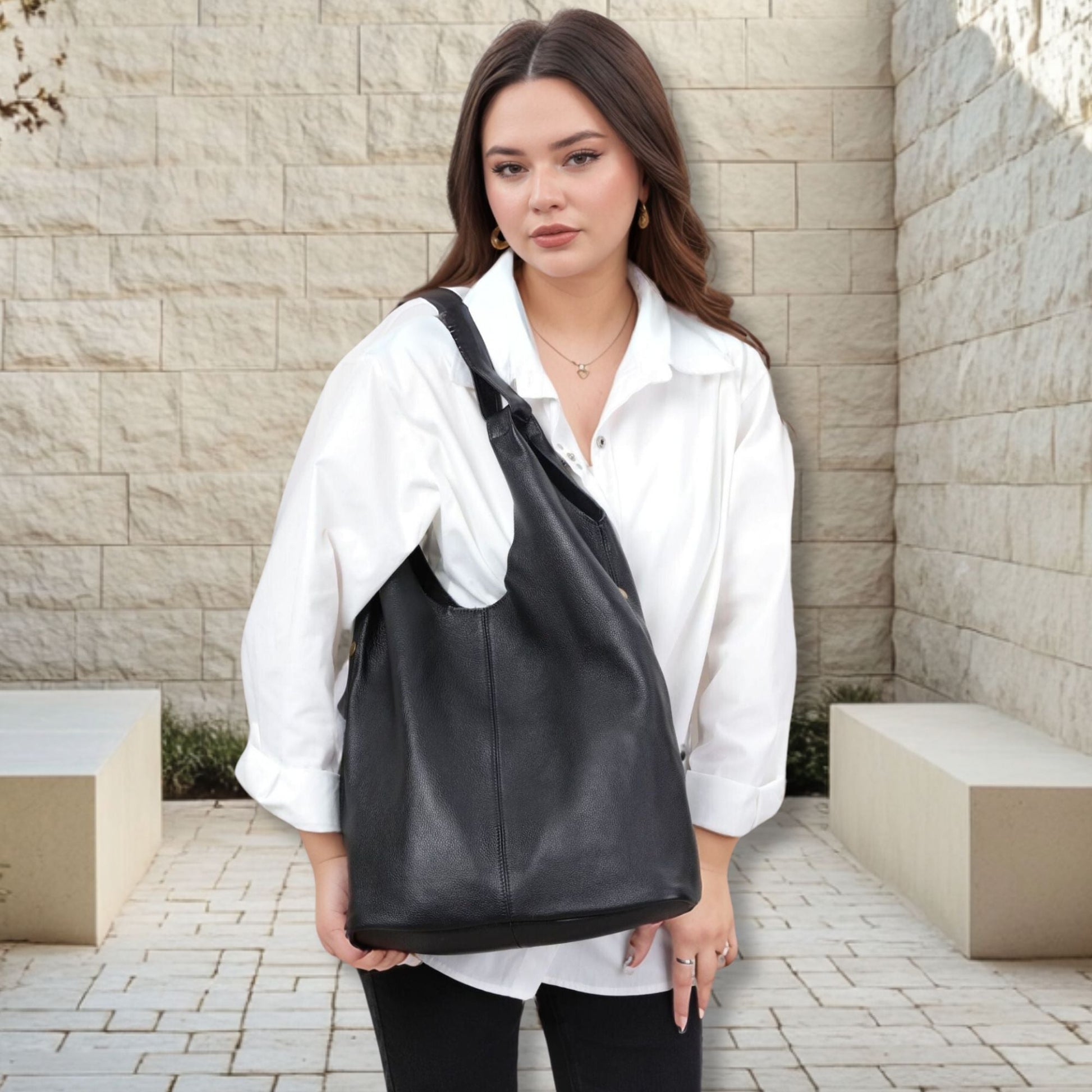 Woman carrying Slouchy Leather Hobo Bag in black, featuring premium genuine leather and spacious design.