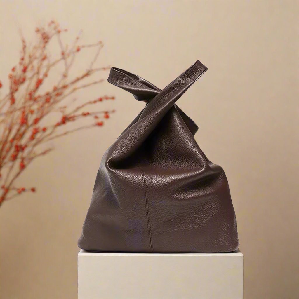 Slouchy leather hobo bag on display in elegant setting.