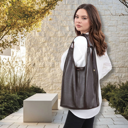 Slouchy Leather Hobo Bag worn by a woman in a stylish outdoor setting.