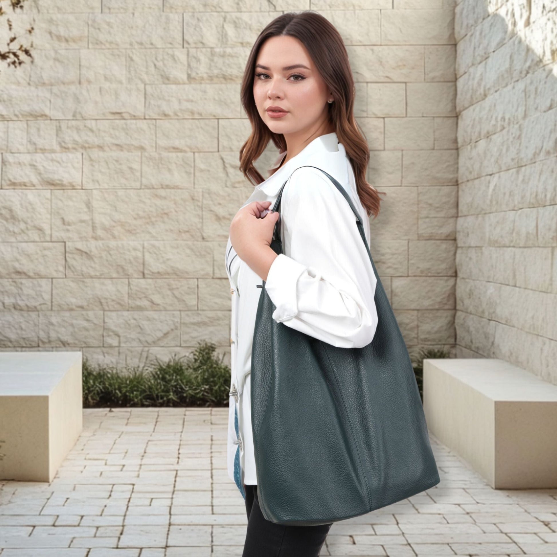 Woman carrying a Slouchy Leather Hobo Bag against a neutral backdrop.