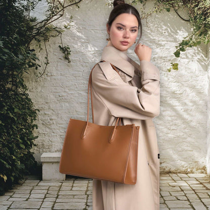 Woman carrying a brown leather tote bag in