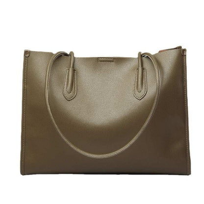 Genuine leather tote bag with reinforced straps and sleek design.