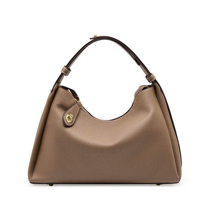 Trapezoid leather crossbody handbag with lychee-patterned texture and adjustable strap.
