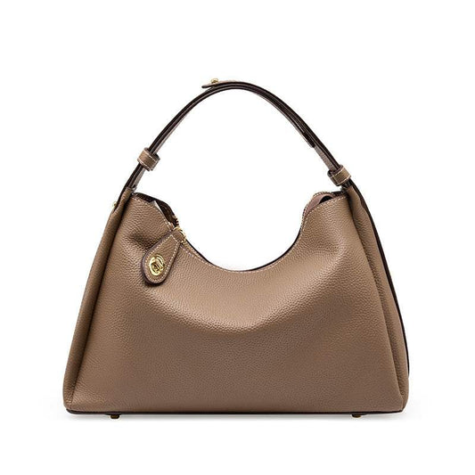 Trapezoid leather crossbody handbag with lychee-patterned texture and adjustable strap.