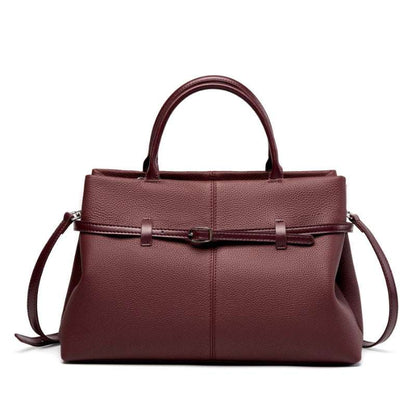 Women's leather briefcase bag in wine red with handles and adjustable strap.