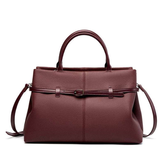 Women's leather briefcase bag in wine red with handles and adjustable strap.