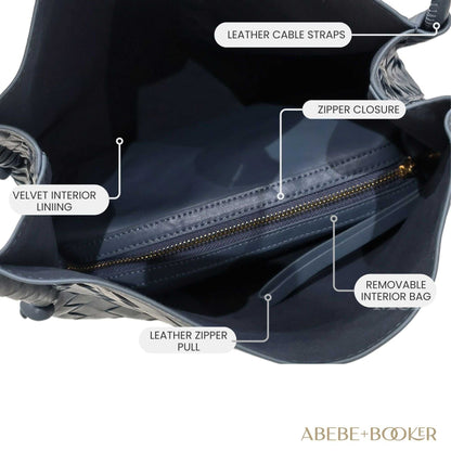 Woven leather tote handbag with spacious interior, leather cable straps, zipper closure,