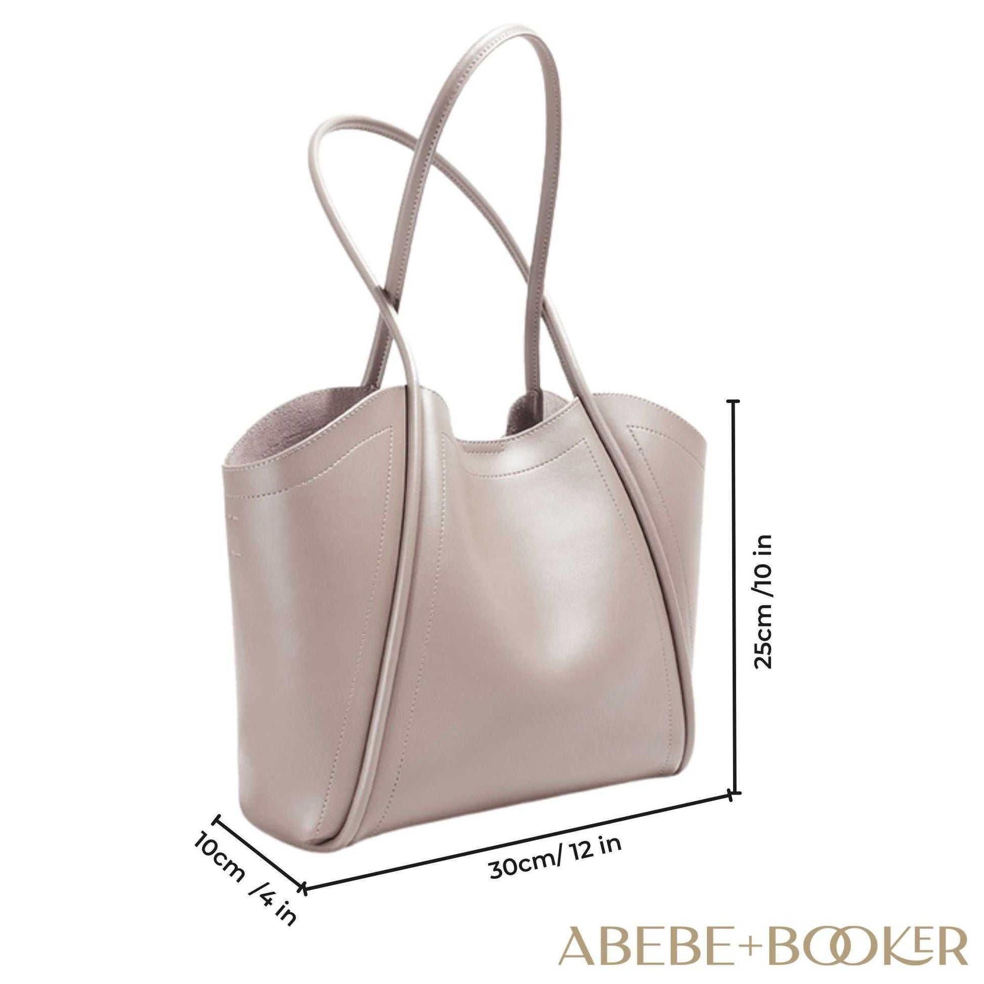 Ladies Leather Tote with rolled straps, spacious interior, and durable genuine leather design.