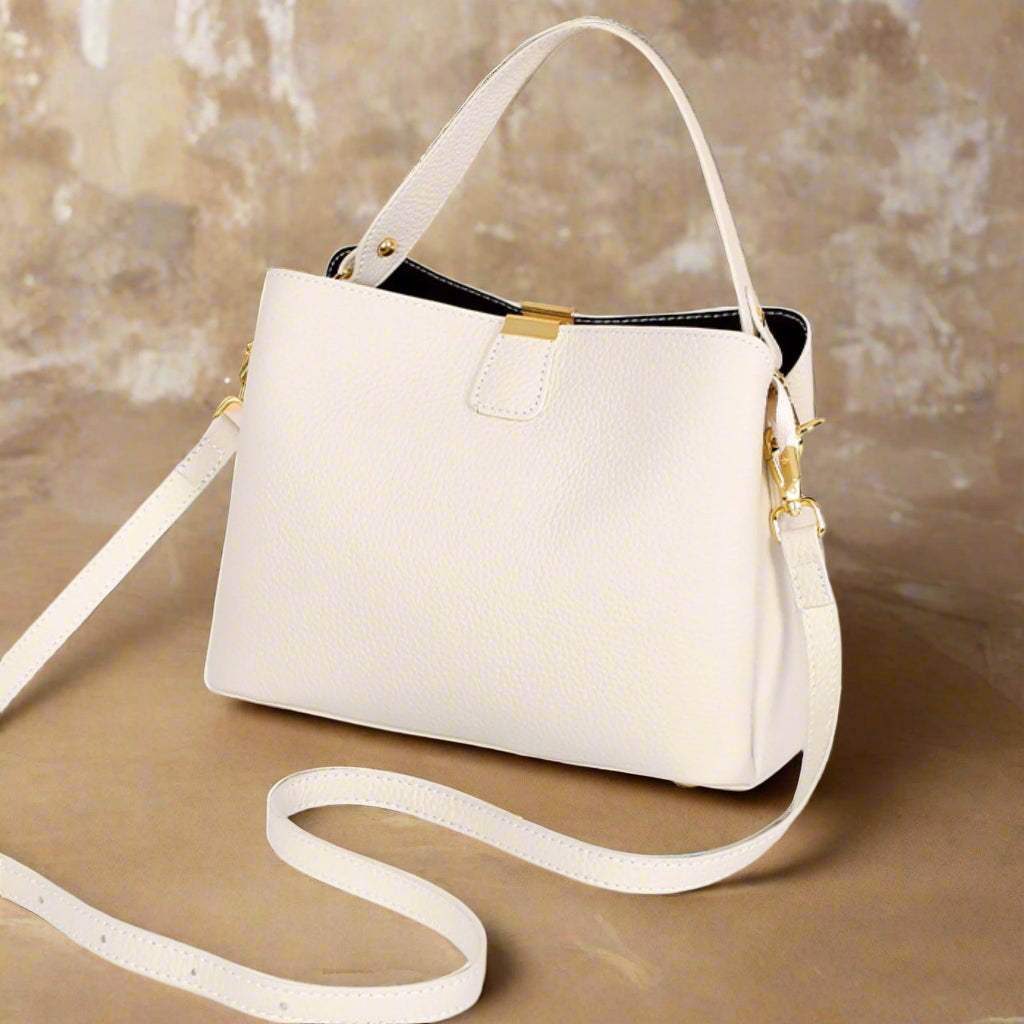 Leather small crossbody purse in cream, featuring adjustable straps and full-grain leather for durability and versatility.